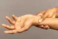 Massaging wrist pain with hand